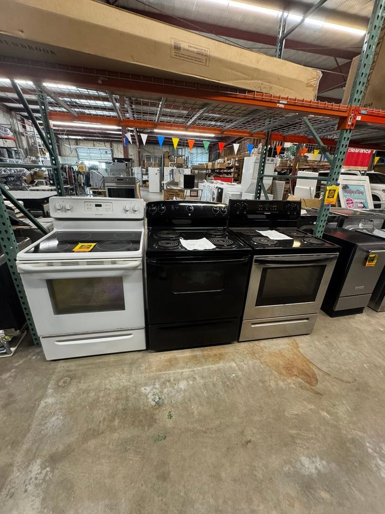 Ranges lined up on the floor — gas and electric, new and scratch-&-dent, priced to move.