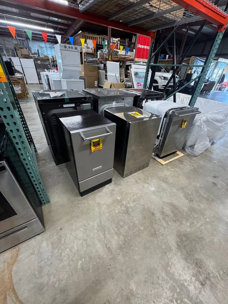 Dishwashers racked and waiting in the warehouse — inventory rotates through the floor weekly.
