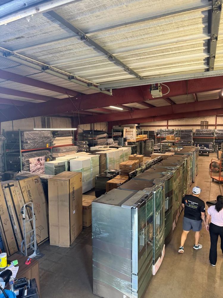 Rows of new inventory at the Appliances 4U warehouse — refrigerators, ranges, washers and more.